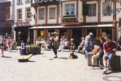 a minstrel playing in the marketplatz